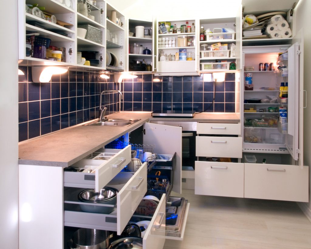 white_kitchen_with_cabinet_doors_and_drawers_opened_or_removed_so_that_real-life_stuff_can_be_seen_in_cabinets